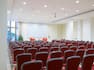 Barocco Conference Room Arranged Theater Style With Red Chairs Facing Projector Screen and Two Red Speaker's Chairs