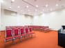 San Martino Meeting Room Arranged Theater Style With Red Chairs Facing Beverage Service Area