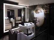 Spa treatment area with sink and art on wall