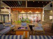 Outdoor Patio Seating Area with Armchairs, Sofas and Firepit at Night