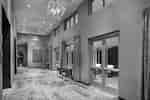Grand Prefunction Meeting Space With Glass Door, Seating, and Windows With Long Drapes,