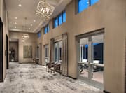 Grand Prefunction Meeting Space With Glass Door, Seating, and Windows With Long Drapes,