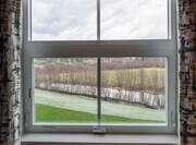 Window With Open Drapes to View of River
