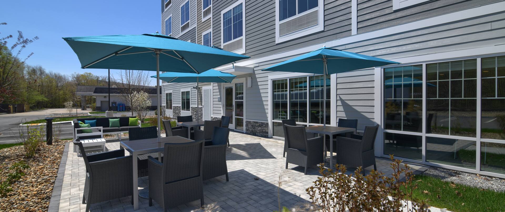 Exterior Patio with Tables and Chairs under Umbrellas