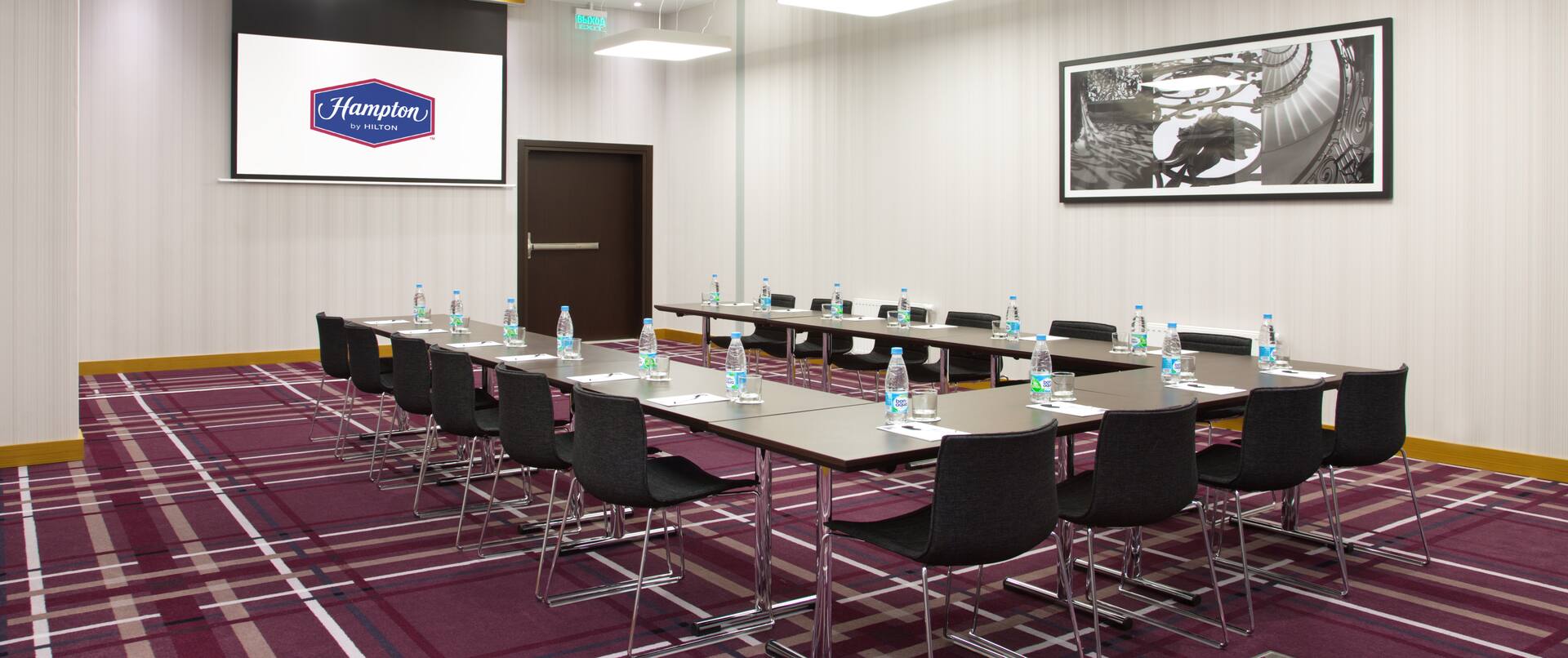 Meeting room with tables and chairs in u-shape