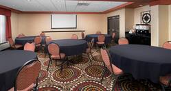 Meeting Room with Round Banquet Tables and Projector Screen