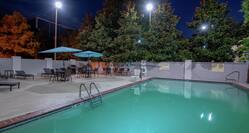 Outdoor Pool and Patio Seating at Night