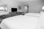 2 beds in room with TV