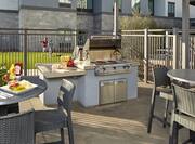 Outdoor Patio Area with BBQ Grill and Dining Area
