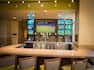 Fully Stocked Bar With Counter Seating, and TV atThe Garden Grill and Bar