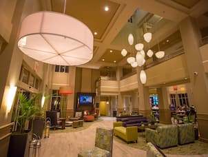 Hotel Lobby Lounge, Decorative Lighting, Upper Levels, and Guests in Dining Area at Night