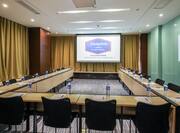 U-Shaped Table and Chairs Setup in Meeting Room with Projector Screen