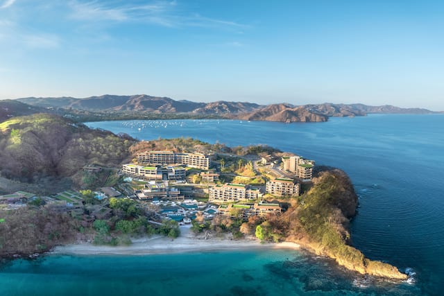 Photo d'un drone de l'extérieur de l'hôtel de loin, montrant l'océan et la côte environnants