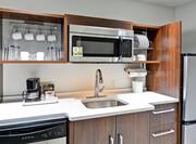 Suite Kitchen with Fridge, Dishwasher, Microwave, Sink and Dishes