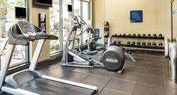 Fitness Center Cardio Machines and Weights with View of Pool
