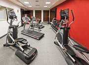 Fitness Center With Cardio Equipment, TV, Large Mirrors, Exercise Ball, Weight Bench, Weight Balls, and Free Weights