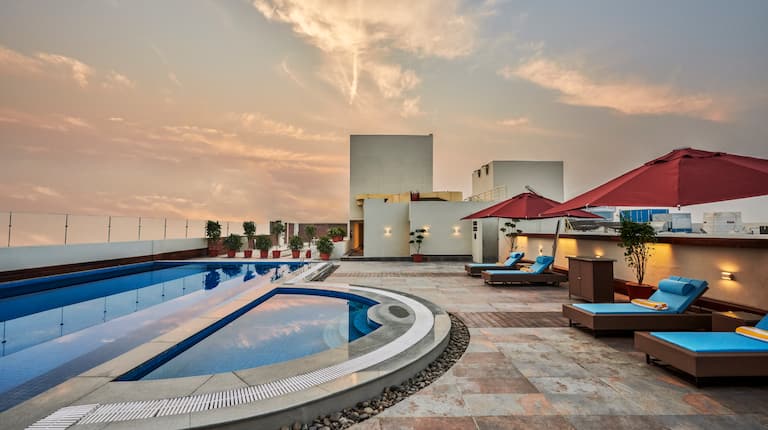 Rooftop Outdoor Swimming Pool and Deck Chairs at Dusk