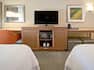 Desk Microwave Coffeemaker and HDTV in Hotel Guest Room with Two Beds