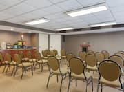 Meeting Room in Theater Layout With Chairs Facing Podium and Beverage Service Area