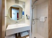 Bathroom with shower, sink and mirror