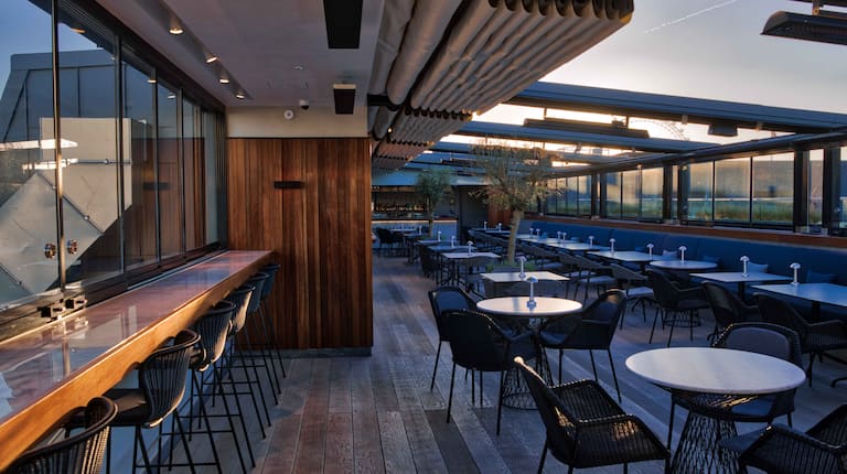 The Rooftop restaurant with open ceiling at sunset