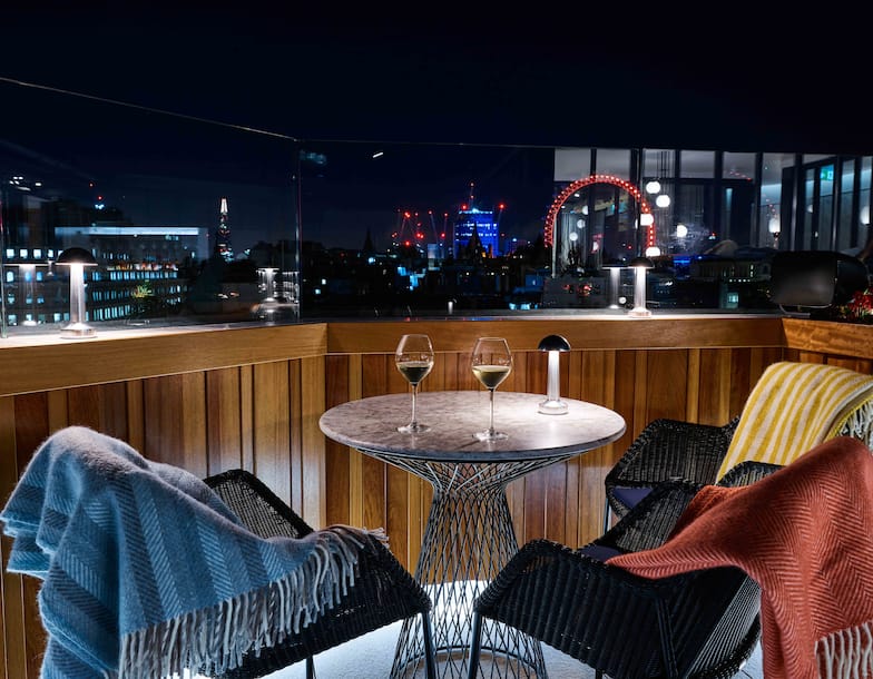 Rooftop bar with view of city at night