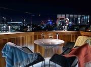 Rooftop bar with view of city at night
