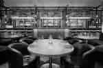 Table and chairs next to bar