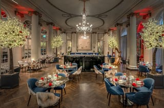 Restaurant Dining Area with Round Tables and Blue Chairs