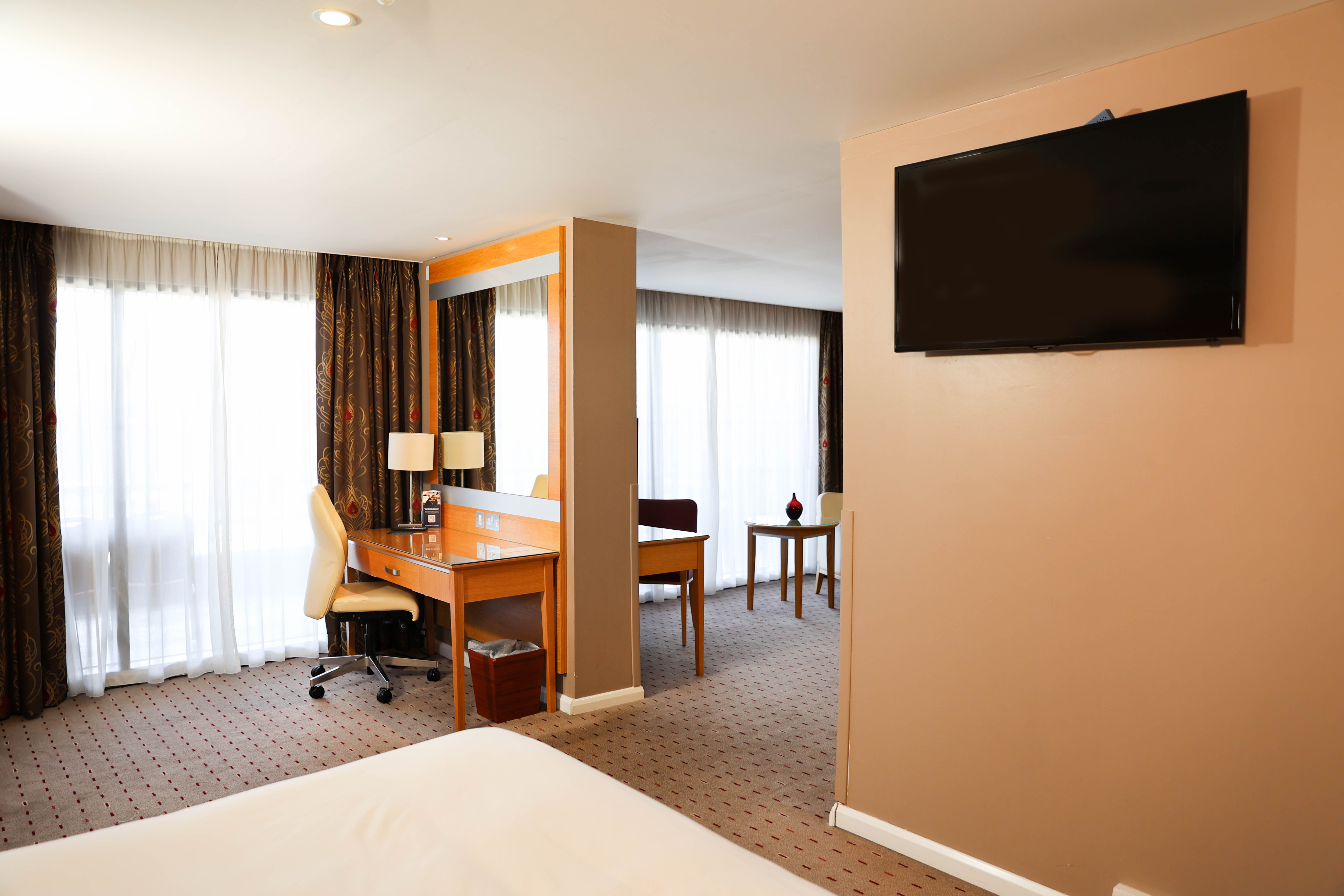 Desk, HDTV and Bed in a Junior Suite