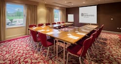 Harlington Suite With Large Windows, U-Table, 14 Red Chairs, Projector Screen, and Presentation Easel 