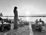 a Woman Standing on the Terrace of a Restaurant Weving Authentic Egyptian Food on the Nile Edge