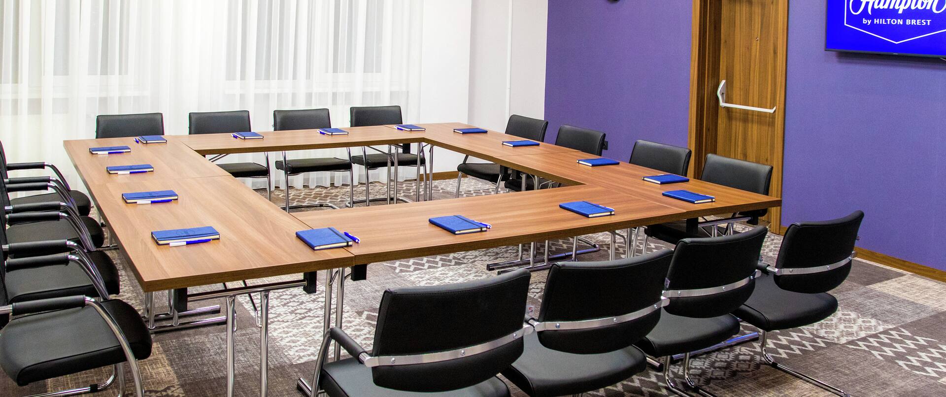 Chairs and Table in Hollow Square Style Setup in Meeting Room