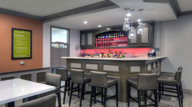 Cocktail Bar With Grey Counter Bar Stools and Table Seating