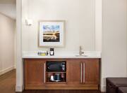 Convenient in-room wet bar featuring sink, microwave, and mini-fridge.