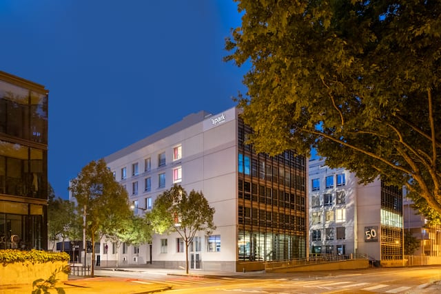 Hotel exterior with roads, trees and buildings