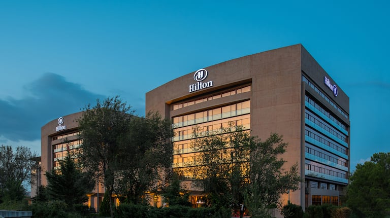 Hotel Exterior with Illuminated Signage at Dusk