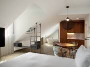 Large Bed in El Atochal Penthouse Suite with HDTV Wet Bar Dining Area and Bathtub