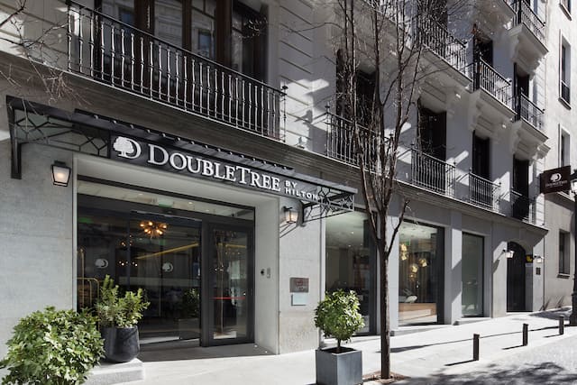 Daytime View of Hotel Exterior, Signage, and Entrance