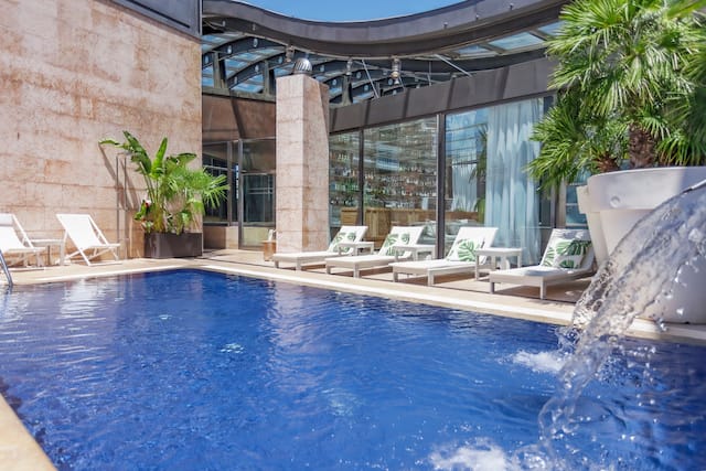 Outdoor swimming pool with loungers