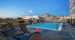 outdoor pool with seating at dusk