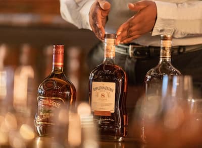 A gentleman presenting a selection of rums at Hilton Rose Hall Resort & Spa, an all-inclusive resort.