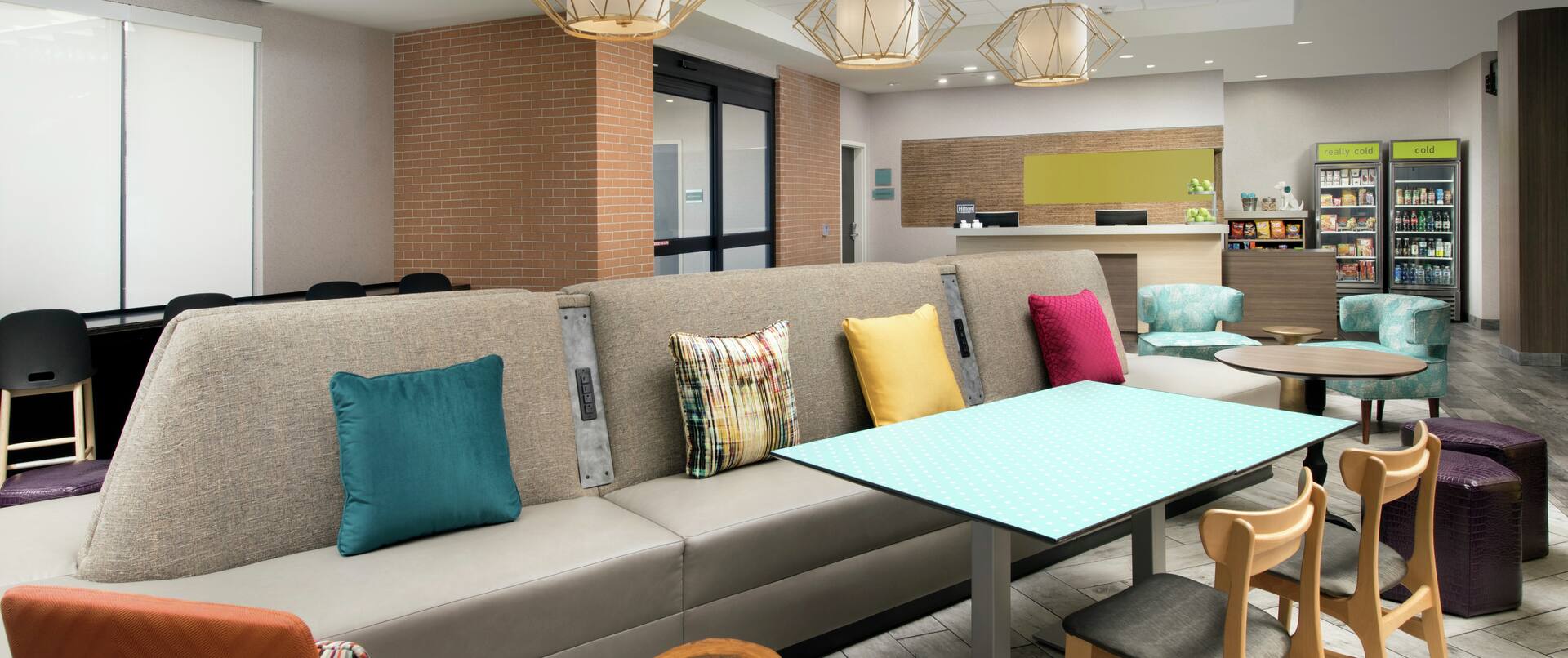 Lounge Seating in Lobby With View of Entrance, Front Desk, and Snack Shop