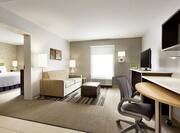 Separate Living Room in Suite with Doorway Open to Bedroom