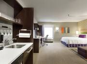 Kitchen and King Bed in Studio Suite