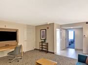 Double Accessible Suite Living Area with Television, Lounge Seating and Entry