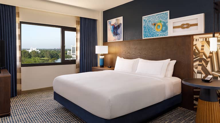 bed in guest suite with artwork and view