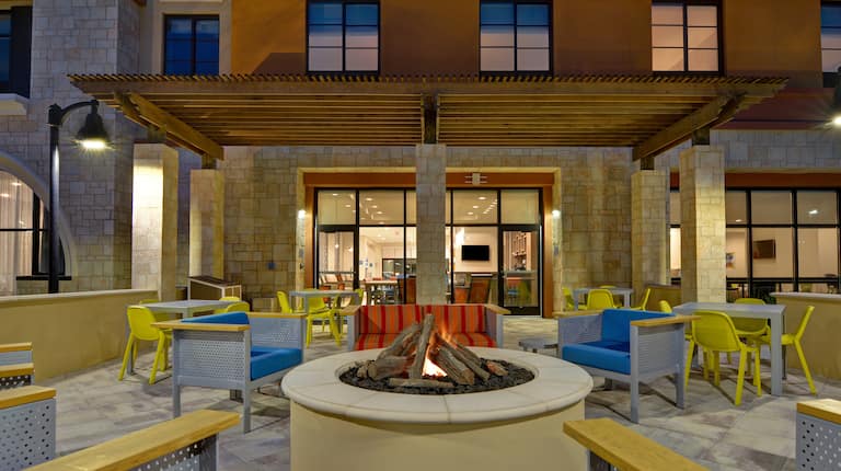 exterior patio with fire pit at dusk