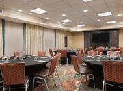 Meeting Room with Round Tables, Chairs and Wall Mounted HDTV