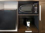 Close Up of Coffee Maker, Mini-Fridge, and Microwave in Guest Room